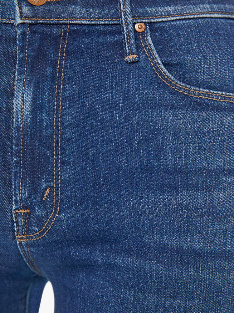 Swatch view of a woman flared, wide-leg jean with a high rise and a clean, 32-inch inseam in a mid blue wash.