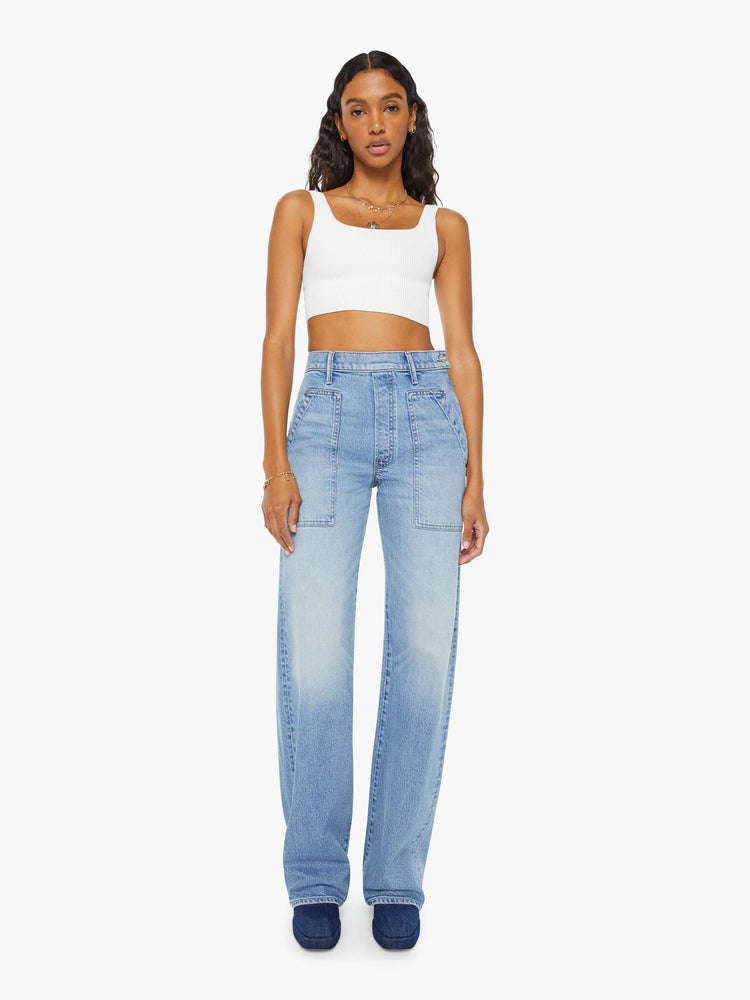 Front view of a woman wide-leg jeans with a super high rise, patch pockets and a long 34-inch inseam with a clean hem in a light blue wash.