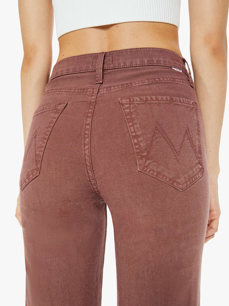 Back close up view of a woman in a brown high-waisted pants with a wide straight leg, zip fly and a long 32-inch inseam with a clean hem.