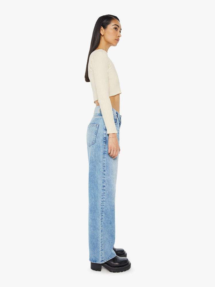 Side view of a light blue super high-waisted jeans with a 29-inch inseam and a loose, slightly baggy fit.