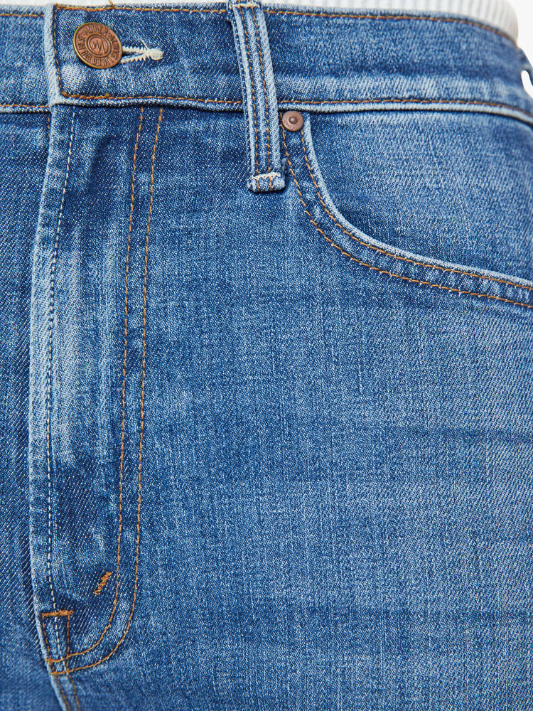 Swatch view of a mid blue high-rise straight-leg jeans with an ankle-length inseam and a frayed step-hem.