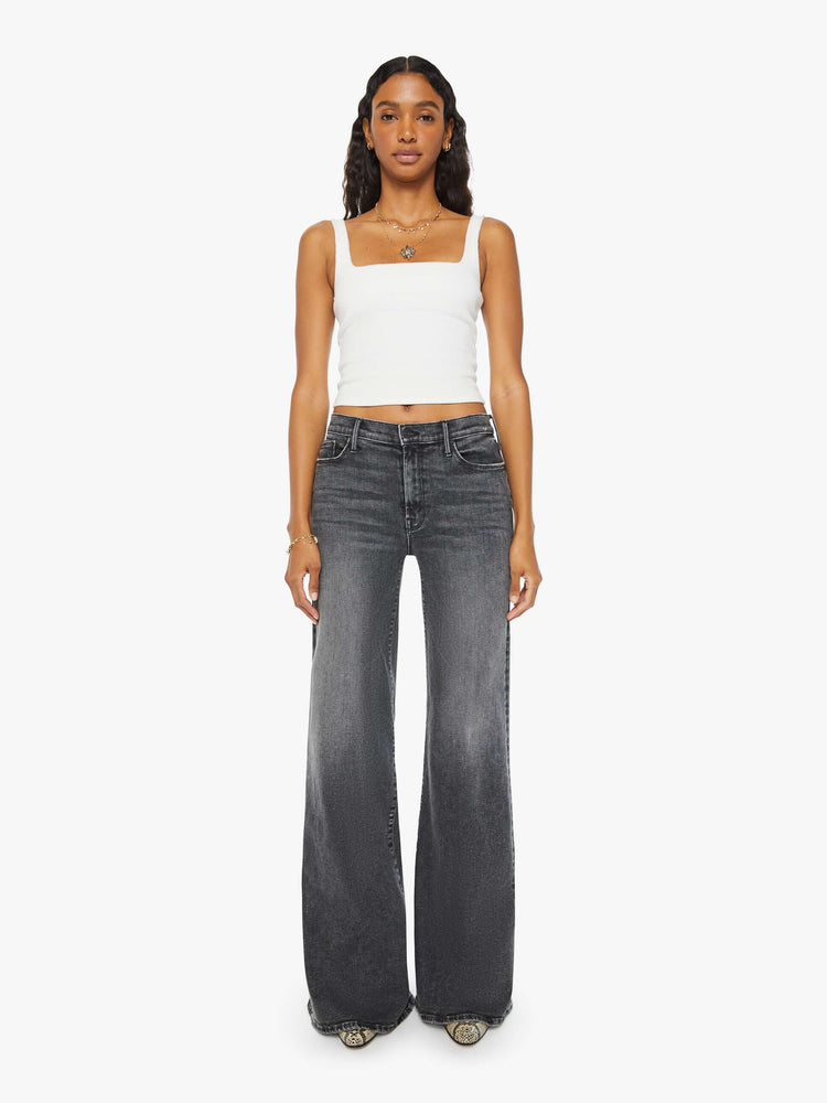 Front view of a woman dark grey flared, wide-leg jean with a mid rise and a clean, 34-inch inseam.