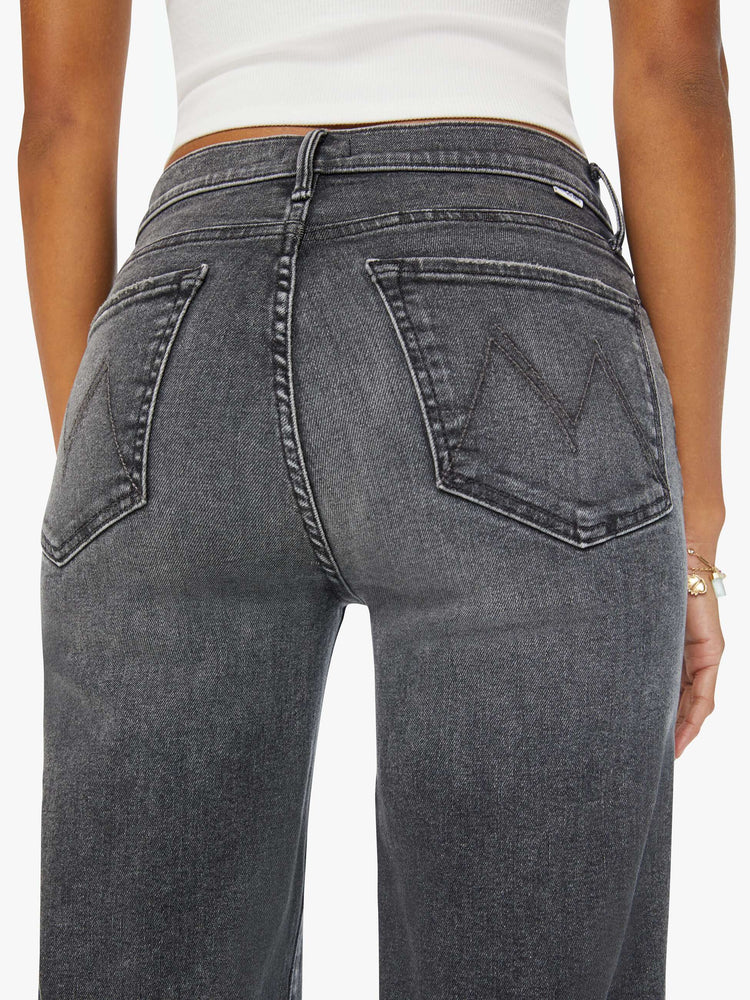 Back close up view of a woman dark grey flared, wide-leg jean with a mid rise and a clean, 34-inch inseam.