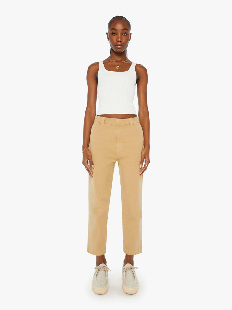 Front view of a woman in khaki slouchy straight-leg pants with a super high rise, slit pockets and a cropped inseam.