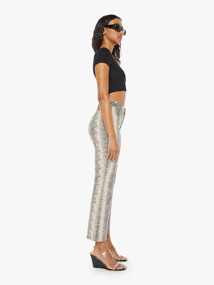 Side view of grey and white snake skin high-rise bootcut has a 28.25-inch inseam and a clean hem.