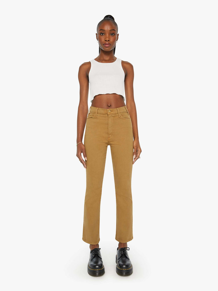 Front view of a woman in a khaki pant with a high-rise flare has a 28.25-inch inseam and a clean hem.