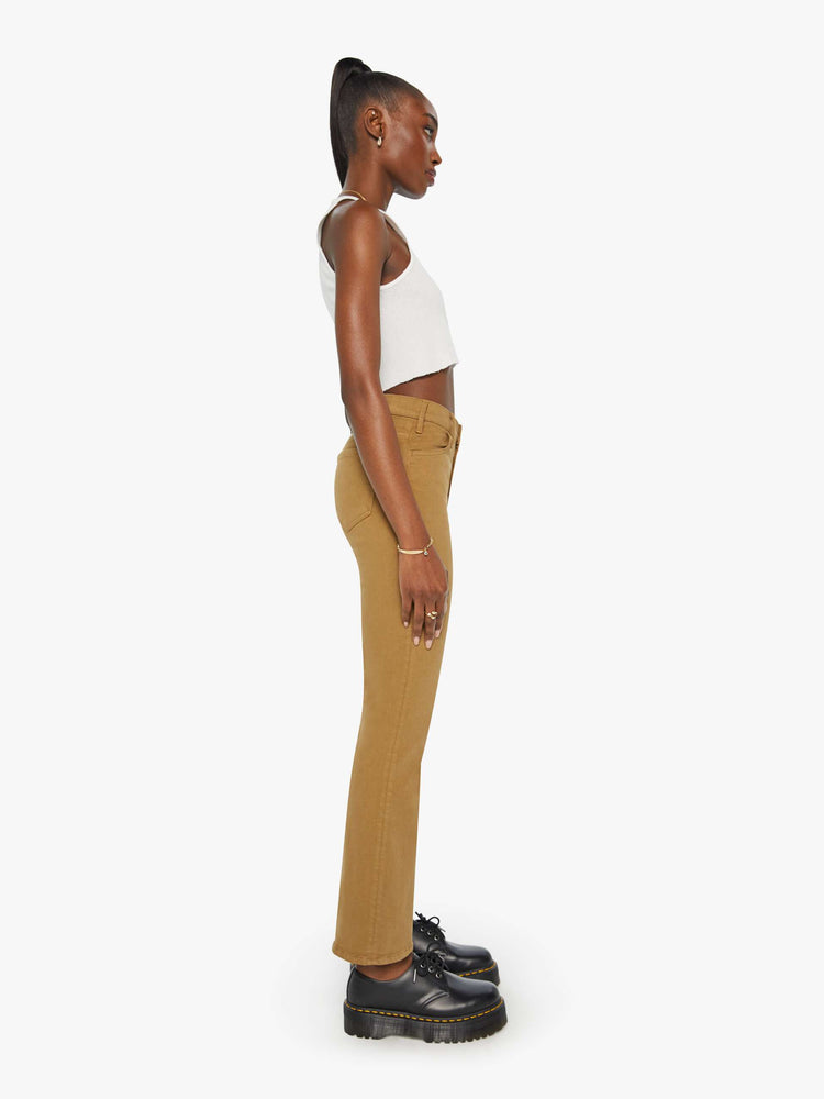 Side view of a woman in a khaki pant with a high-rise flare has a 28.25-inch inseam and a clean hem.