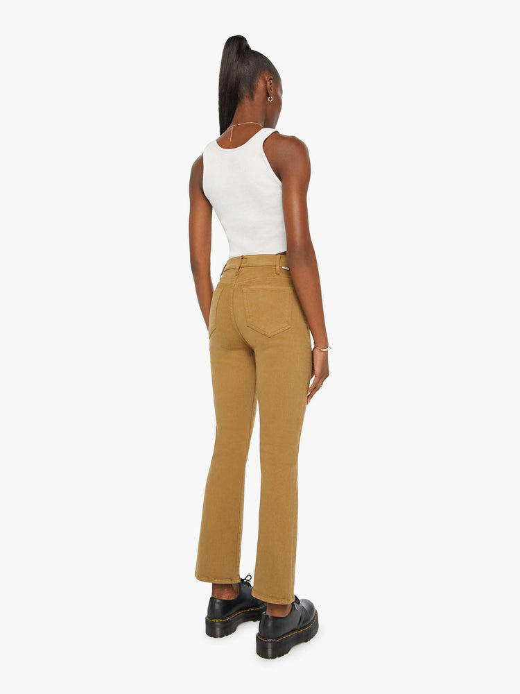 Back view of a woman in a khaki pant with a high-rise flare has a 28.25-inch inseam and a clean hem.