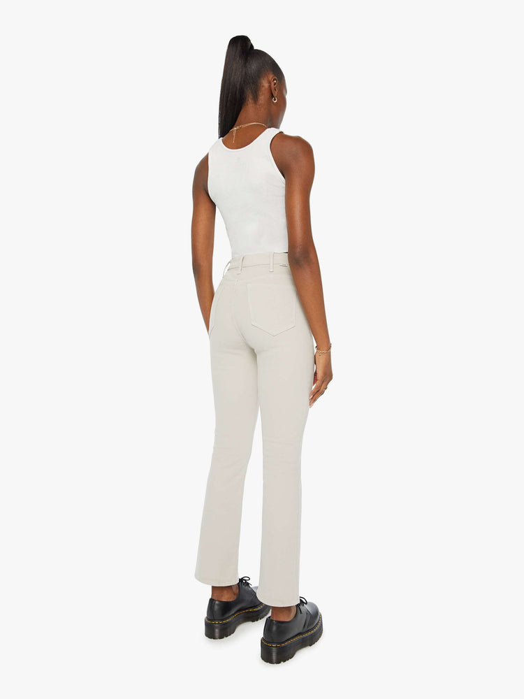 Back view of a woman in a high-rise  flare has a 28.25-inch inseam and a clean hem.