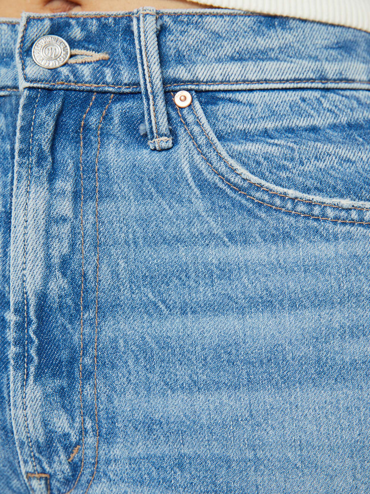 Swatch view of a woman high rise flare with a long 32-inch inseam and a clean hem in a half light blue and mid blue wash.