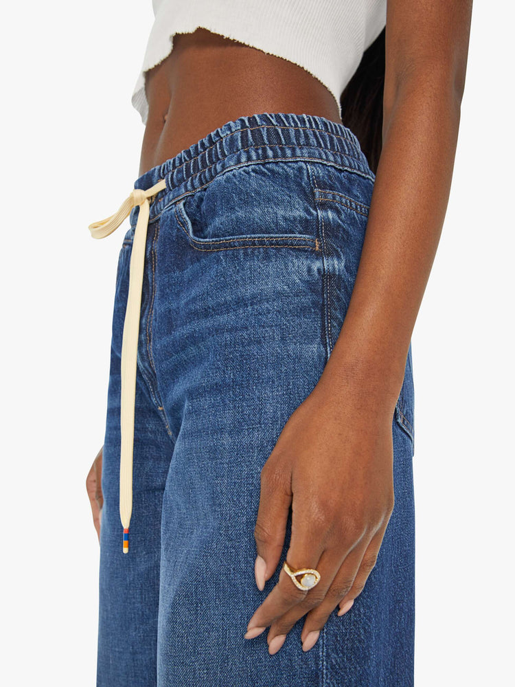 Swatch view of a woman in a dark blue wide-leg jean with a relaxed fit that's designed to sit on the hips with an elastic drawstring waistband, 32-inch inseam and a clean hem. 