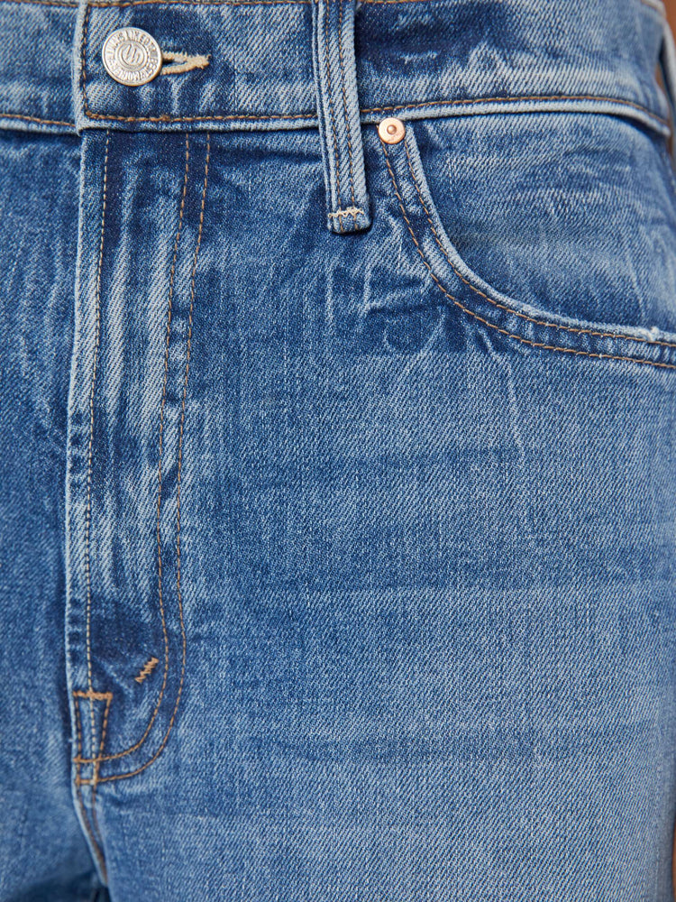 Swatch view of a woman in a mid-blue wash wide-leg jeans feature a high rise with a slightly dropped crotch, low-set back pockets, a slouchier fit designed to sit on the hips and a 31-inch inseam.