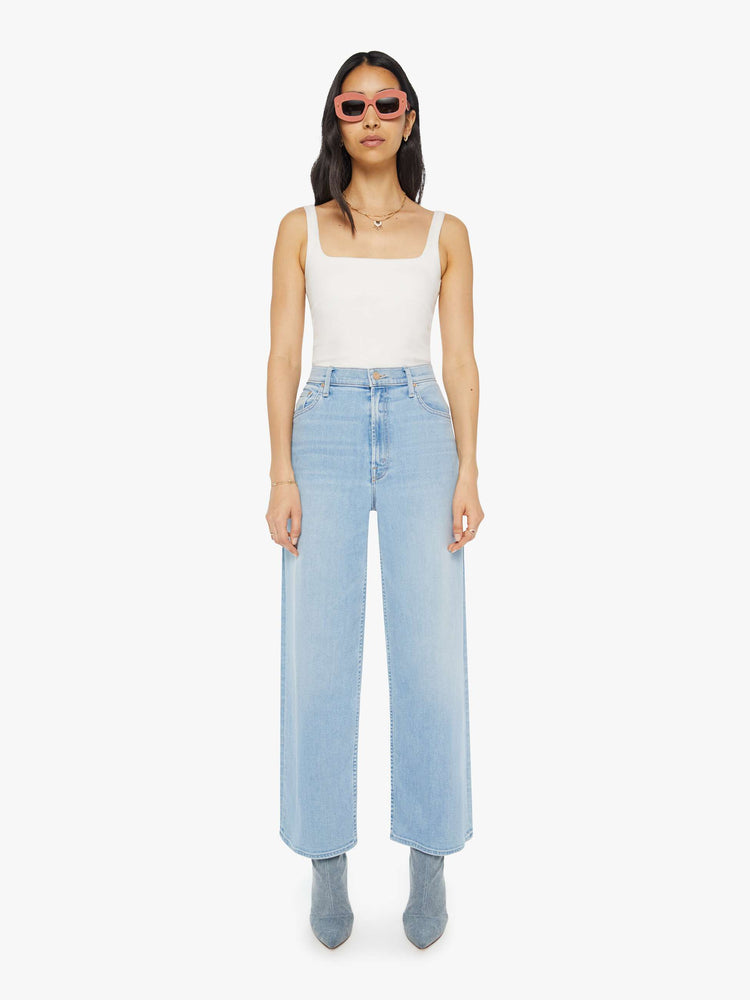 Front view of a woman Super high-rise jeans with a loose wide leg, zip fly and a 28.25-inch inseam with a clean hem in a light blue wash.