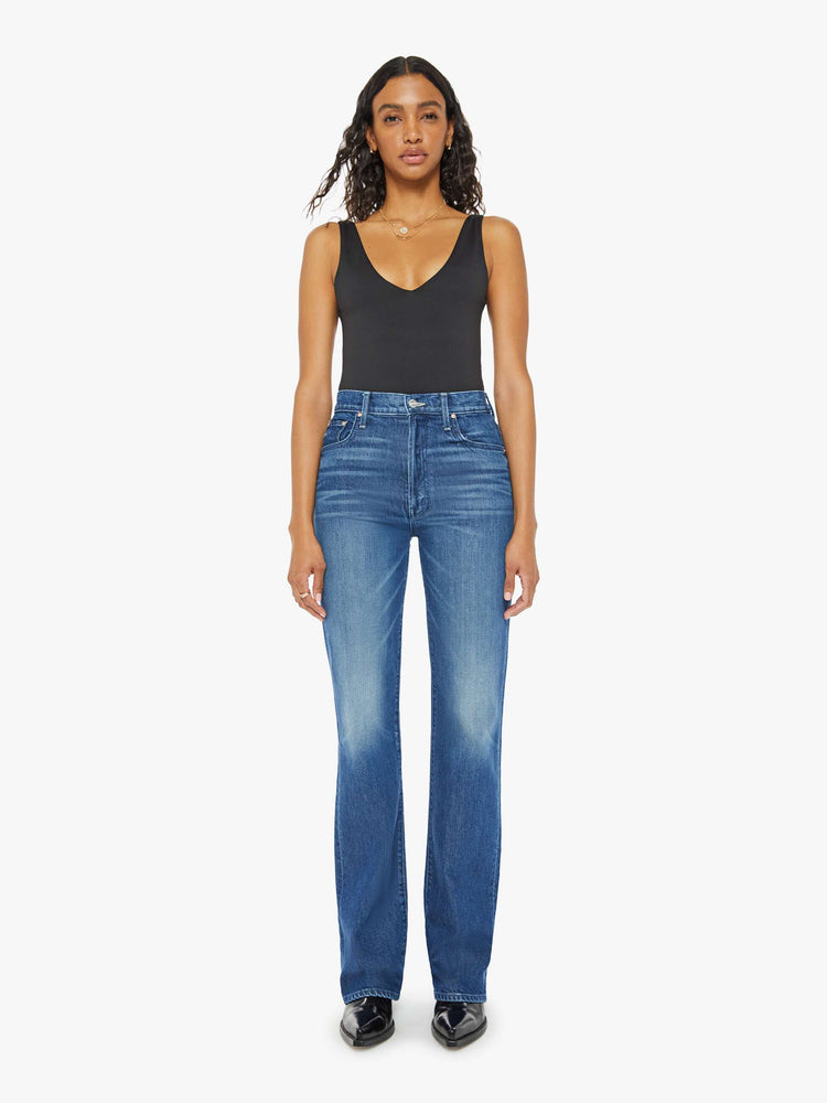 Front view of a woman med blue high-rise jeans with a wide straight leg, zip fly and a long 34-inch inseam with a clean hem.