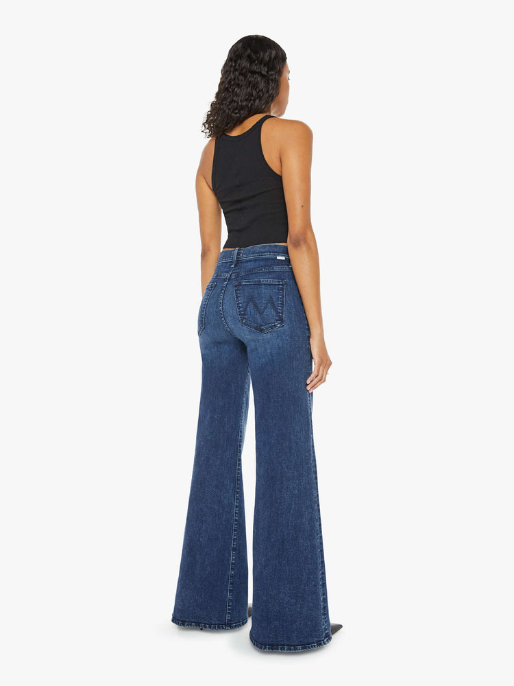 Back view of a dark blue high-waisted wide leg has a button fly, 32-inch inseam and clean hem.