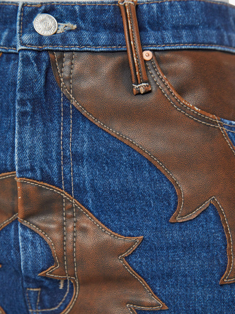 Swatch view of a woman super high-waisted bootcut jeans with a 34-inch inseam and clean hem in a dark blue wash with a faux leather applique.