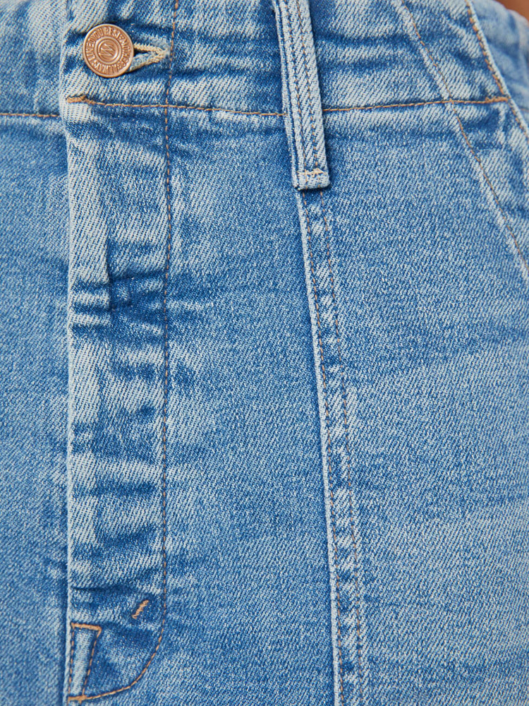 Swatch view of a woman in a super high-waisted pant with a wide straight leg, button fly, oversized patch pockets and a cropped inseam in a light blue wash.