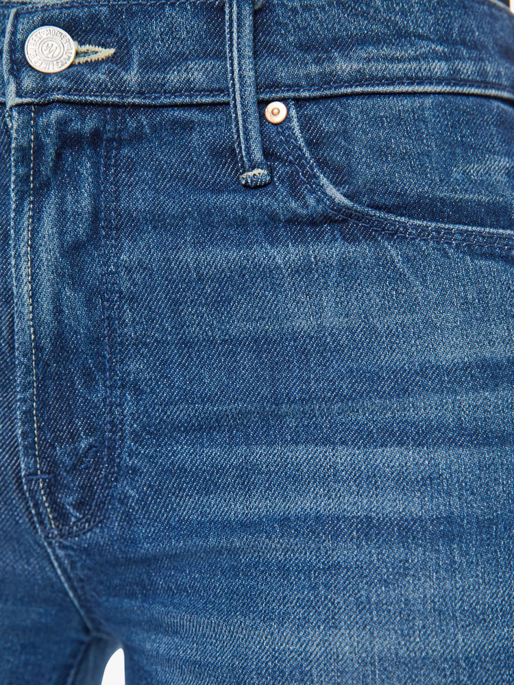 Swatch view of a med blue wash super wide-leg jeans with a high rise, a slouchy fit, flared leg and a long 32-inch inseam with a frayed hem.