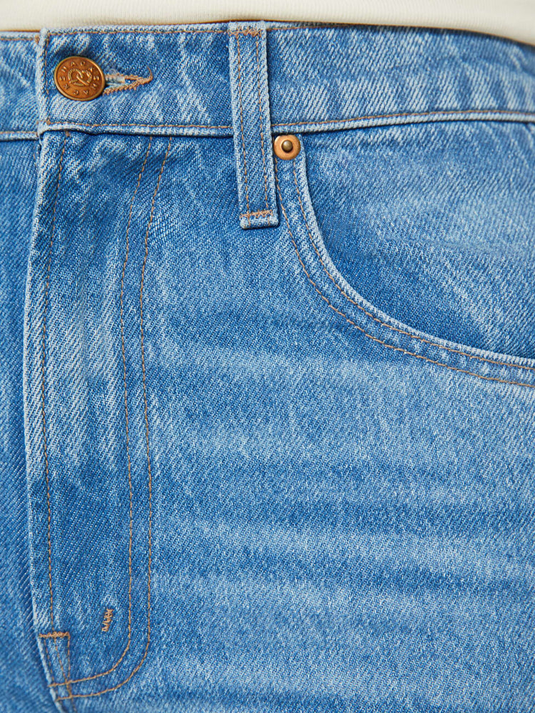 Swatch view of a woman in high-waisted light blue jeans have an extreme flare and a long 34-inch inseam with a clean hem. 