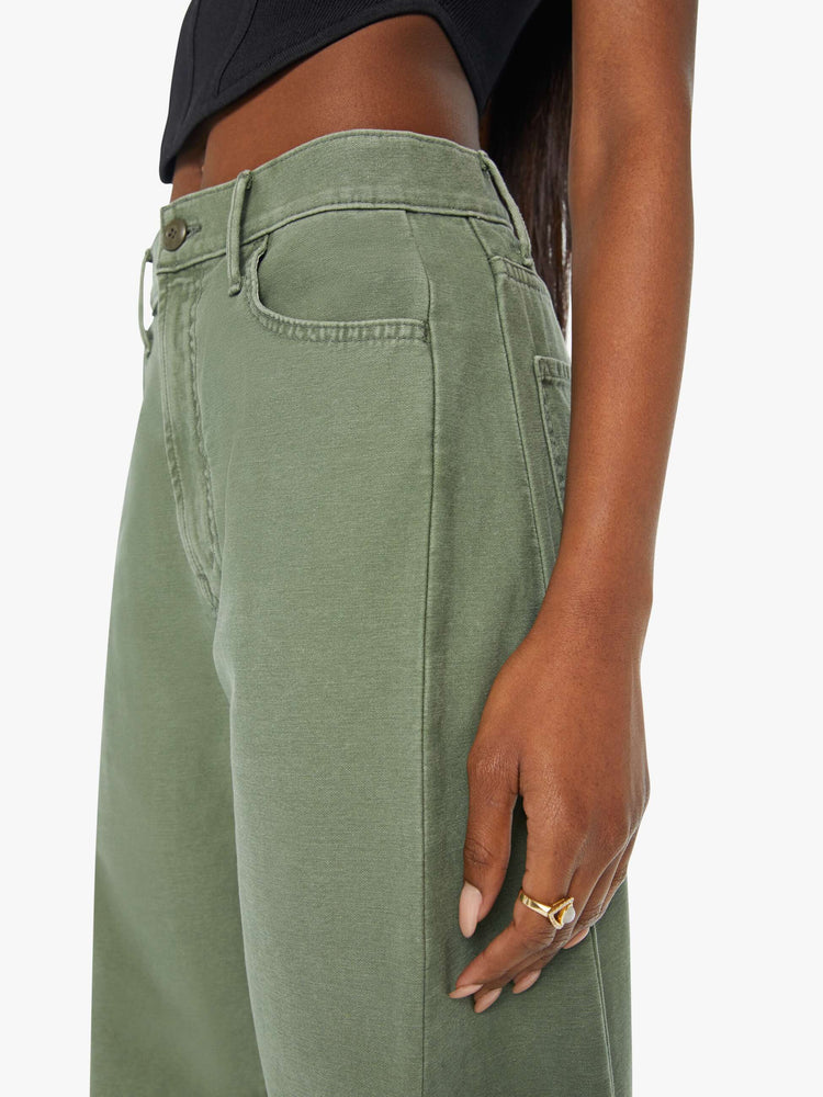 Swatch view of a woman in army green high-waisted pants with a full barrel leg and clean hem.