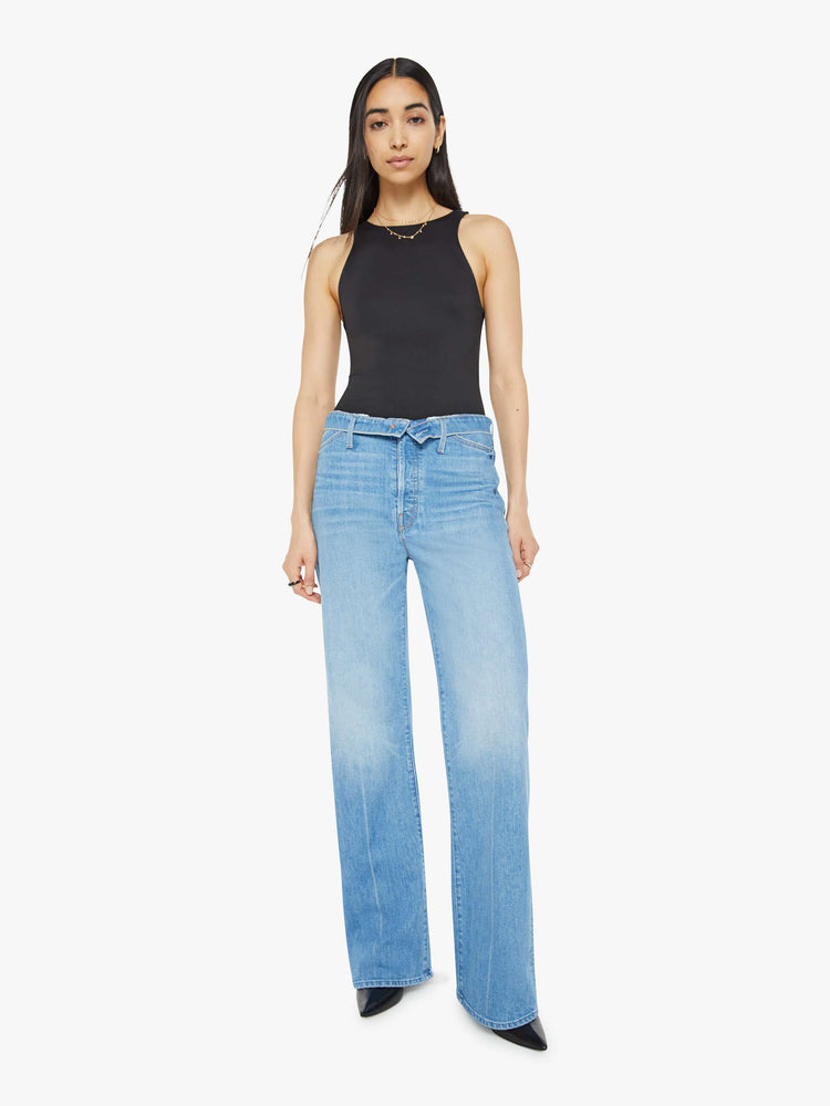 Front view of a woman in mid blue wash high-rise, straight-leg jeans have a foldover waistband, long 32-inch inseam and a loose fit. 