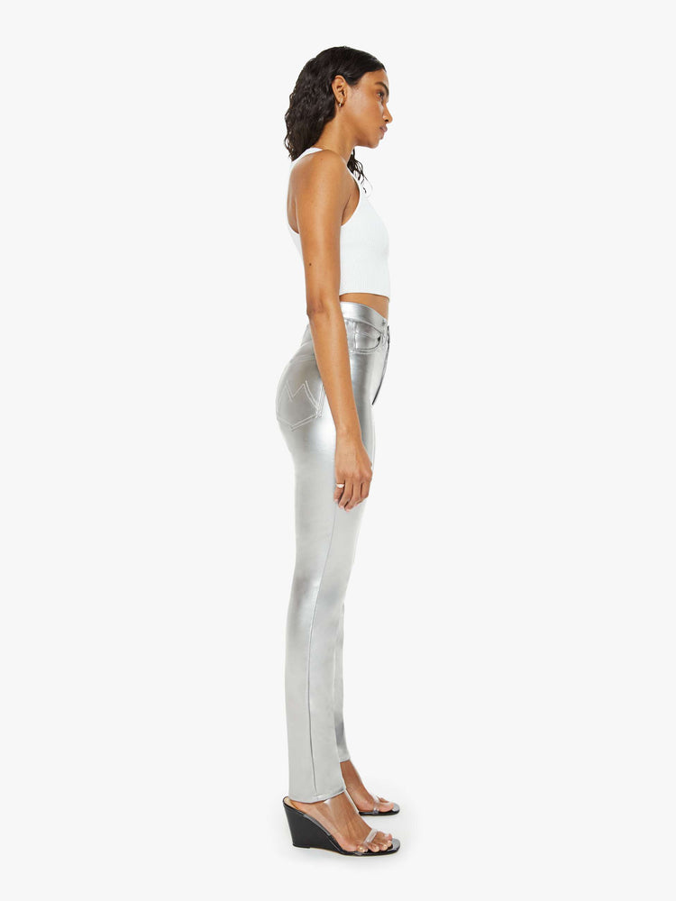 Side view of a woman metallic faux leather super high-waisted skinny  pant with a long 31-inch inseam and a clean hem.