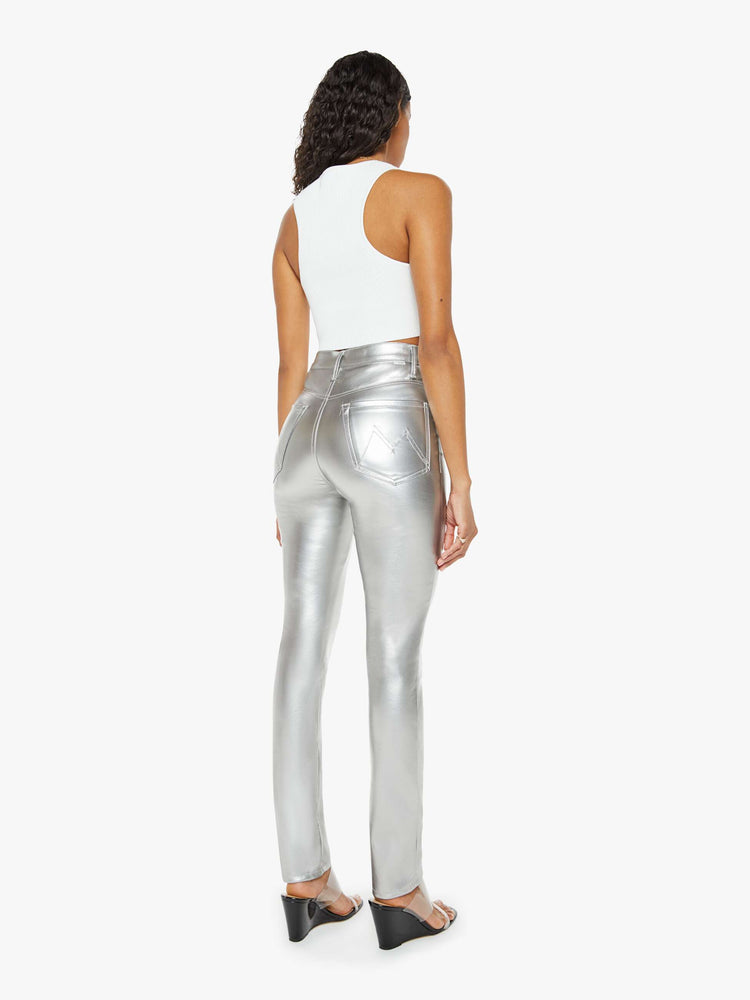 Back view of a woman metallic faux leather super high-waisted skinny  pant with a long 31-inch inseam and a clean hem.