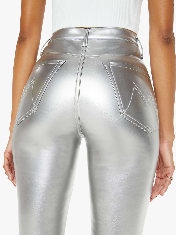 Close up back view of a woman metallic faux leather super high-waisted skinny  pant with a long 31-inch inseam and a clean hem.