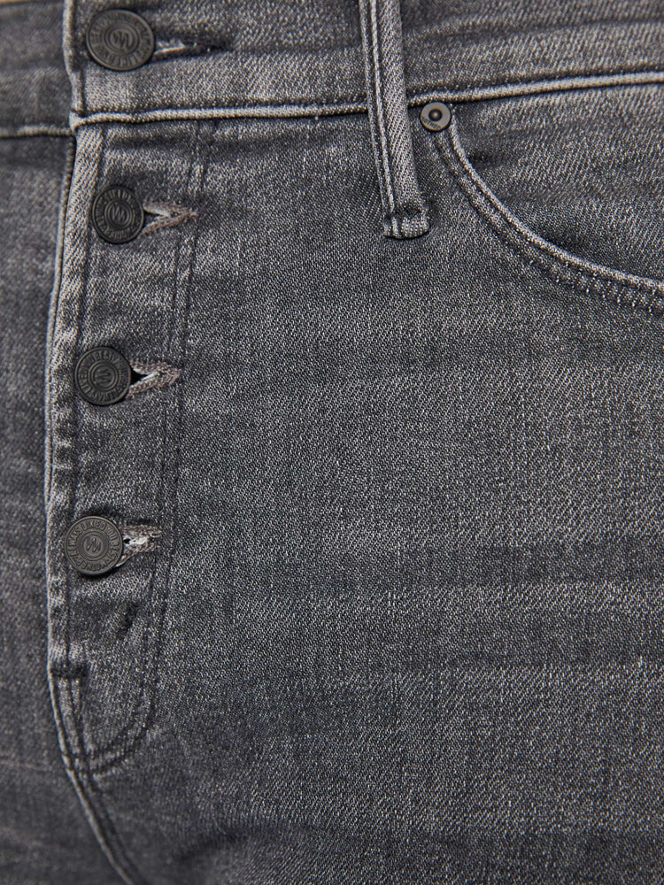 Swatch view of a woman in a dark grey mid rise straight leg jean with an exposed button fly and an ankle length inseam.