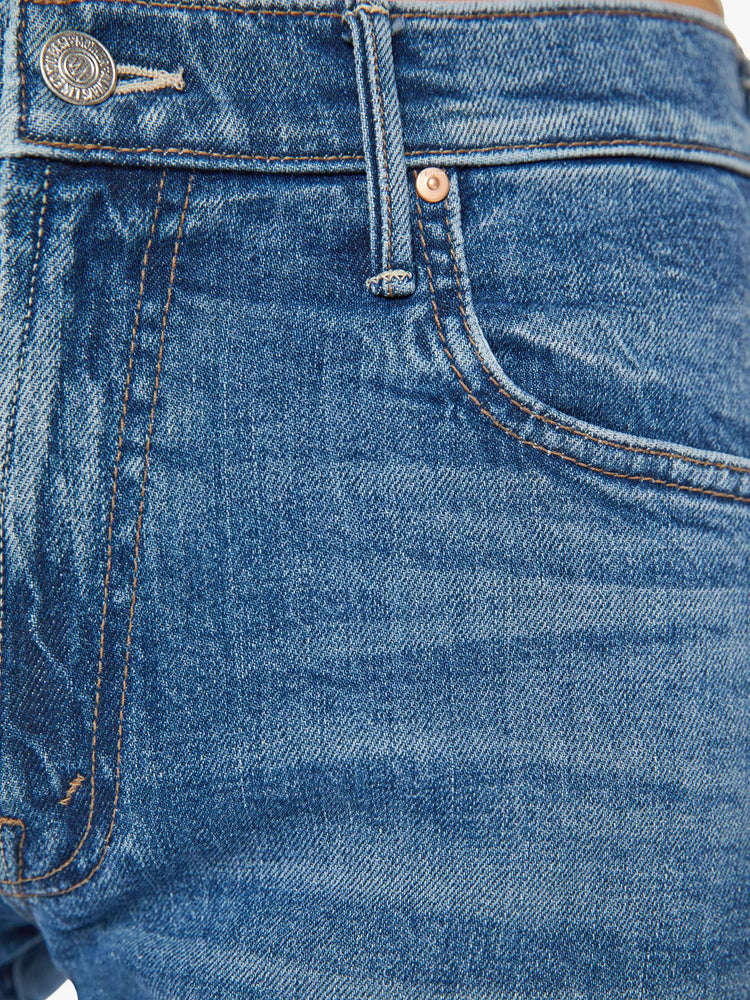 Swatch view of a med blue mid-rise jeans with a loose fit, wide leg and ankle-length inseam with a clean hem.