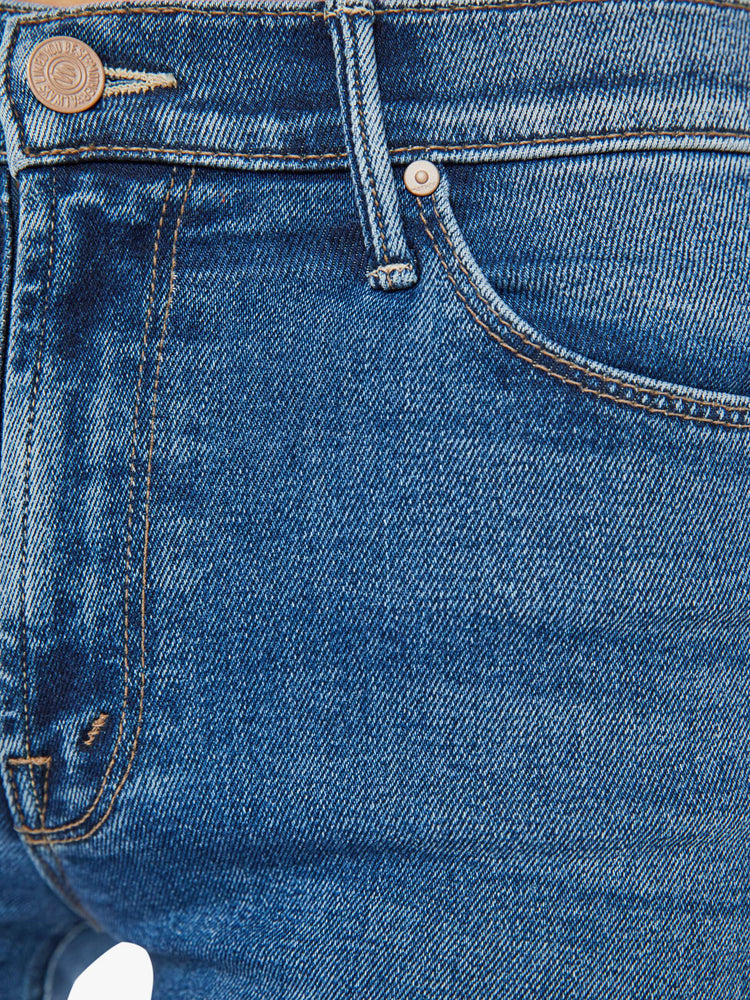 Swatch view of a woman mid blue  mid-rise straight leg with a 28.25-inch inseam and a frayed hem. 