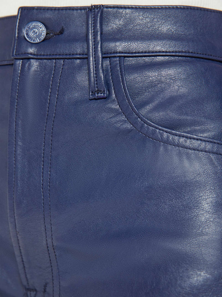 Swatch view of a woman in a super high-waisted pant with a wide, curved leg, a 32-inch inseam and a clean hem in a navy faux leather with fringe down the leg.