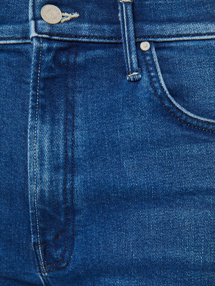 Swatch view of a woman in a dark blue straight leg jean designed  to be worn loose and low at the hips with an ankle length inseam.