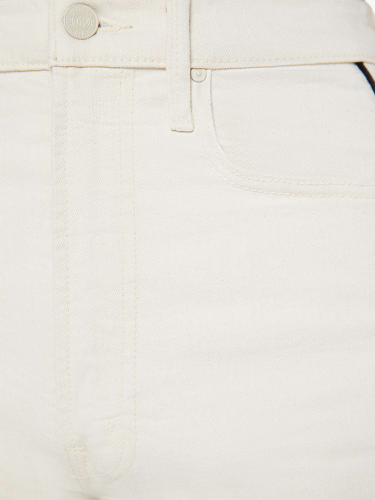 Swatch view of a woman in a super high-waisted jean with a wide, curved leg, an ankle-length inseam and a clean hem in a creamy white wash.