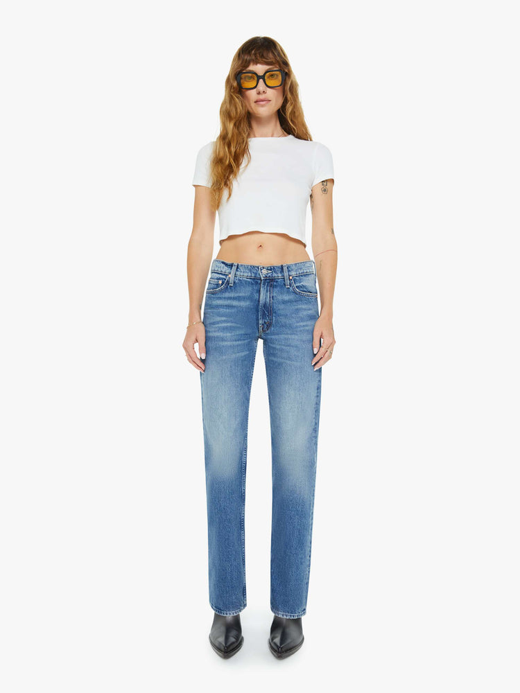 Front view of a woman in a  straight leg with a bit of a kick, the jean features a mid rise, full-length inseam and clean hem in med blue wash.