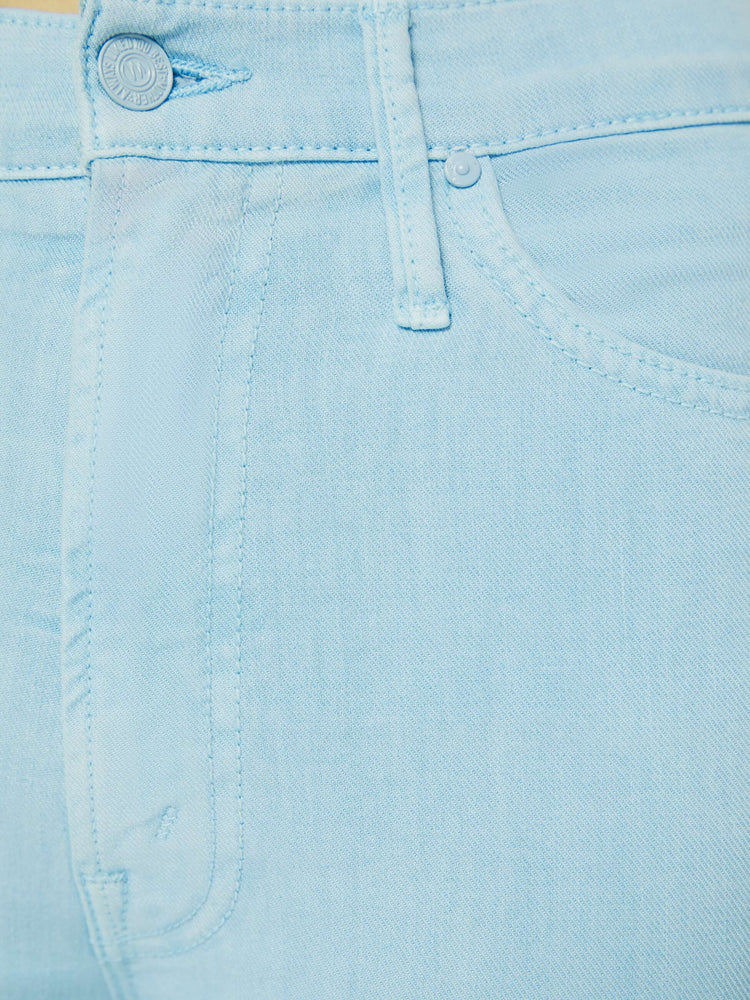 Swatch view of a woman in high-waisted bootcut hits at the ankle with a frayed step hem in a bright sky blue.