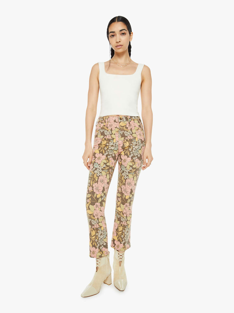 Front view of a woman in a high-rise bootcut has an ankle-length inseam and a clean hem in a floral print.