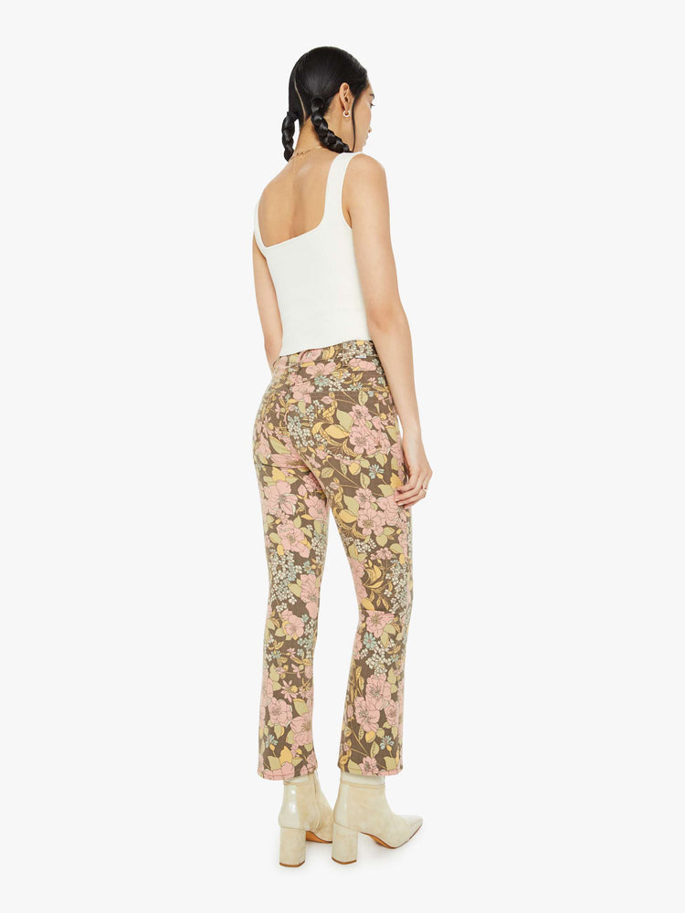 Back view of a woman in a high-rise bootcut has an ankle-length inseam and a clean hem in a floral print.