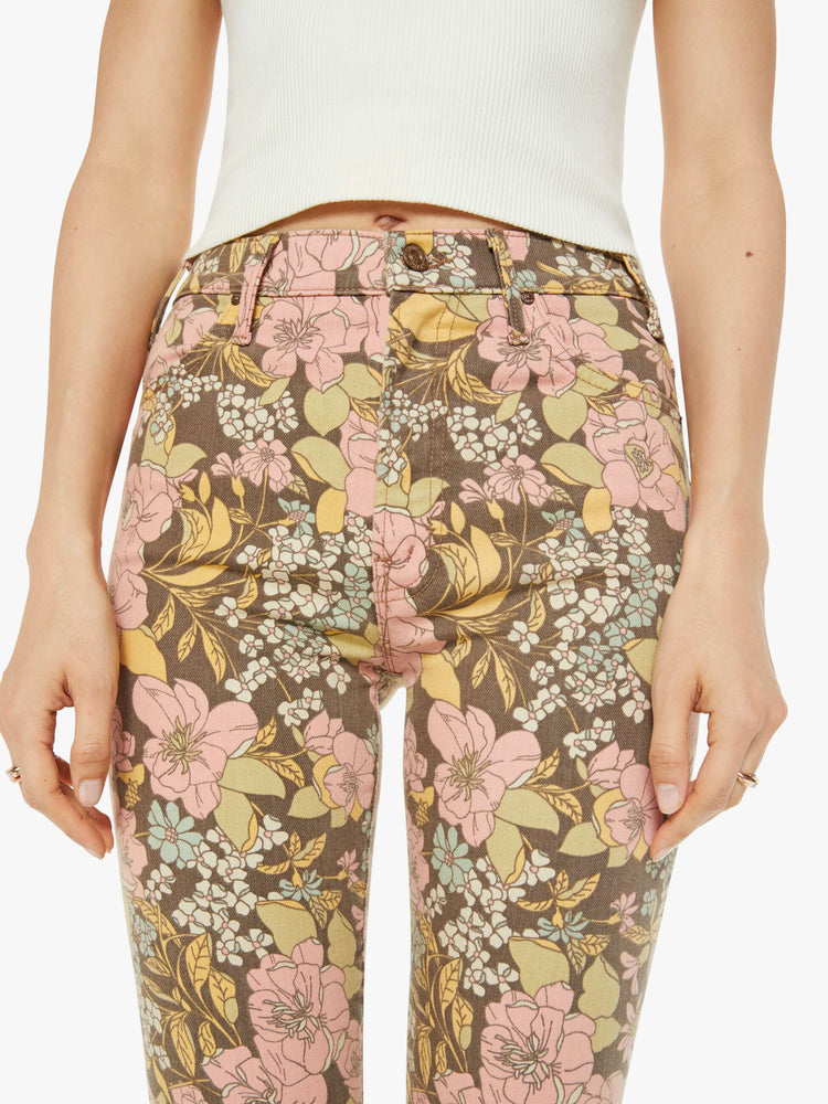 Waist close up view of a woman in a high-rise bootcut has an ankle-length inseam and a clean hem in a floral print.