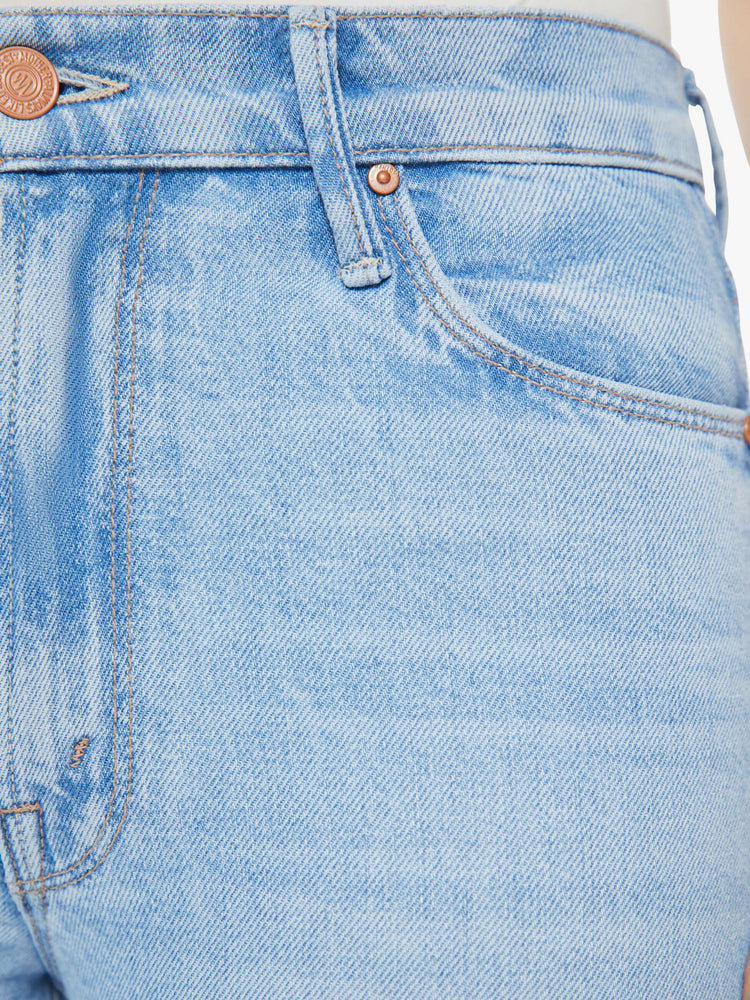 Swatch view of a woman in a light blue jean with a high rise flare with a long inseam.