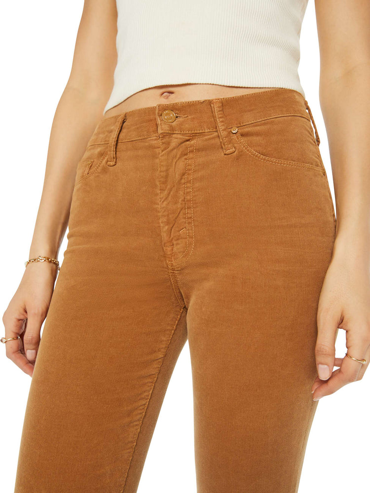 Close up view of a woman in a mid rise with a 31-inch inseam and a clean hem in a golden orange corduroy.