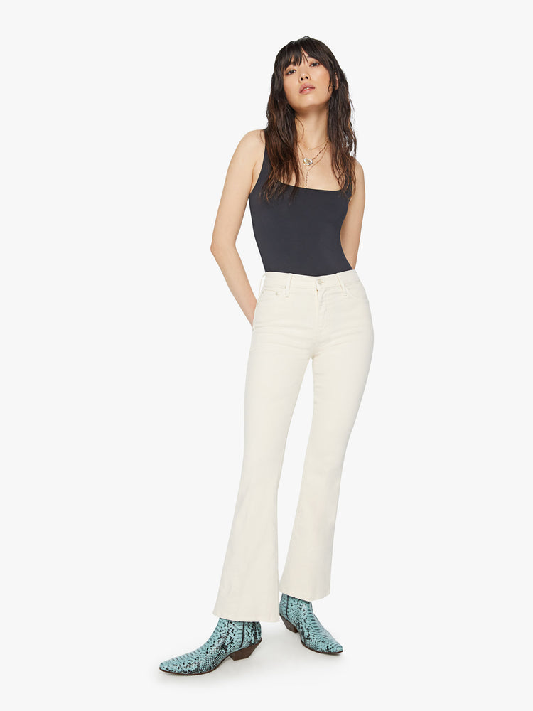 Front view of a woman midrise flare with a 31-inch inseam and a clean hem in an off white color.