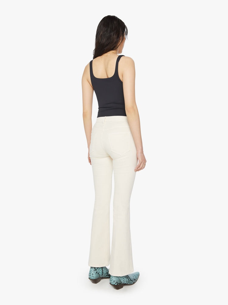 Back view of a woman midrise flare with a 31-inch inseam and a clean hem in an off white color.