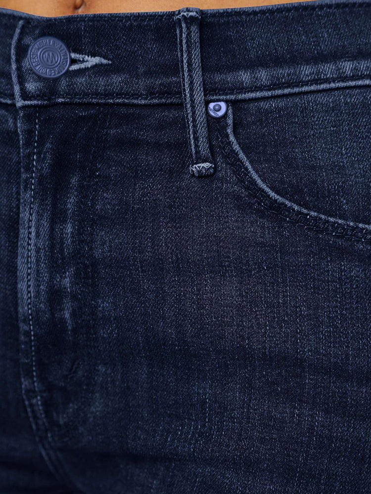 Swatch view of a woman in dark blue wash jeans with a mid-rise straight leg hits at the ankle with a clean hem.