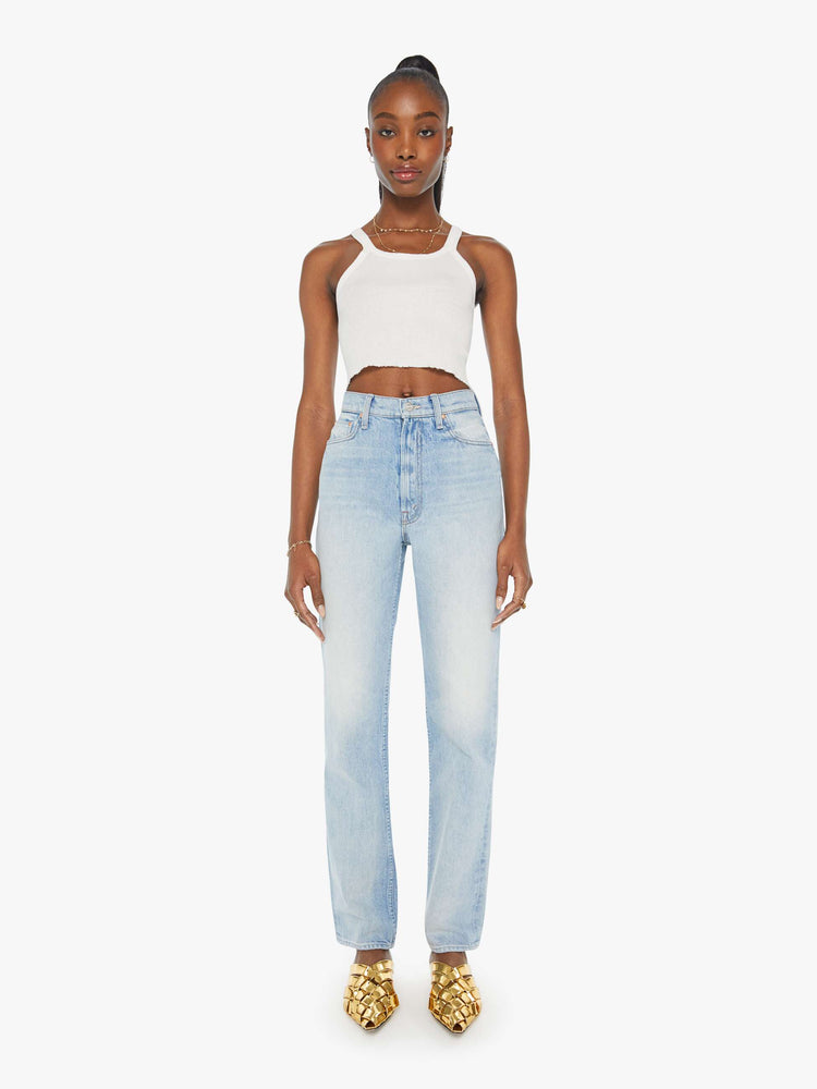 Front view of a woman high-waisted  straight-leg jeans with a 30-inch inseam and a clean hem in a light blue denim.