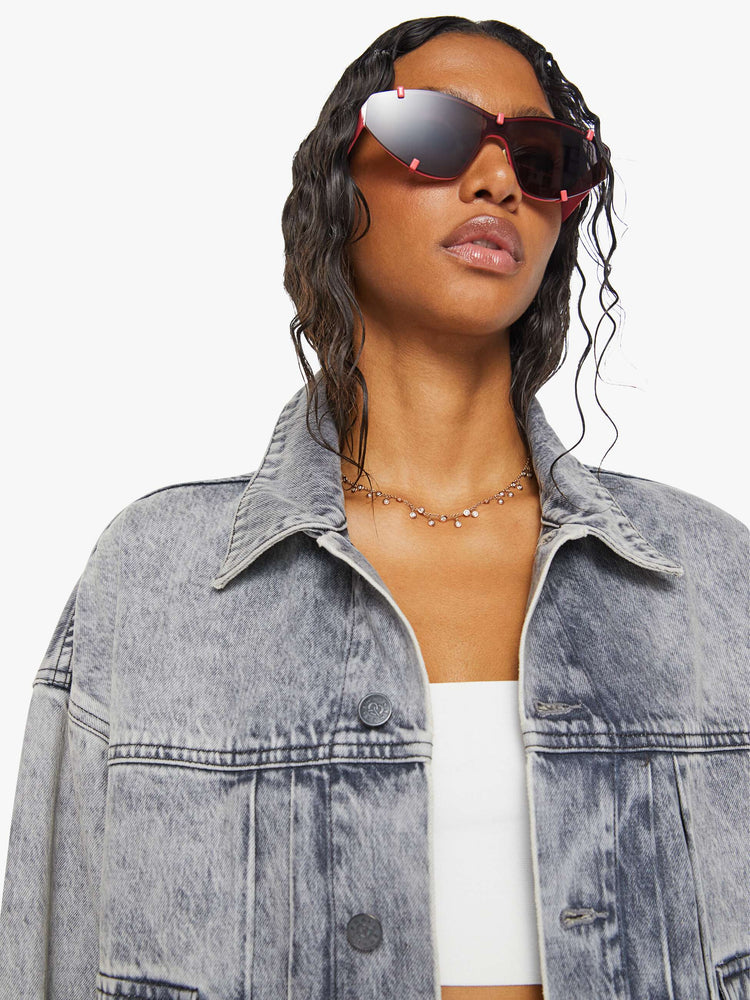 Swatch view of a woman in acid-washed grey oversized denim jacket features large patch pockets, drop shoulders and a boxy fit. 