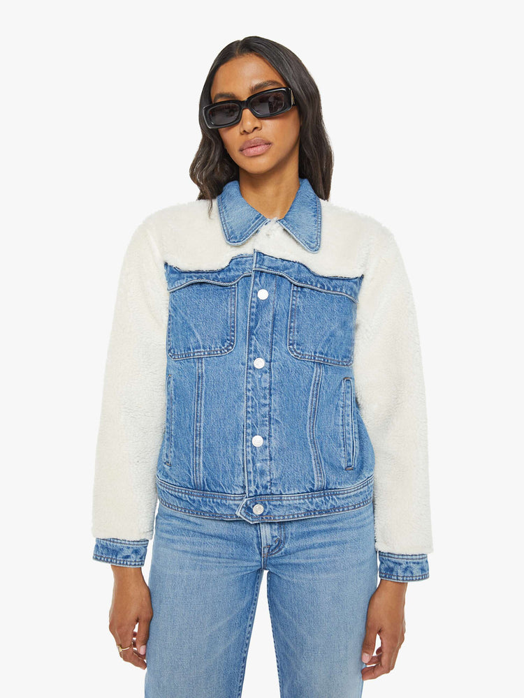 Front view of a mid blue classic denim jacket with faux sherpa with patch pockets and a boxy, slightly cropped fit.