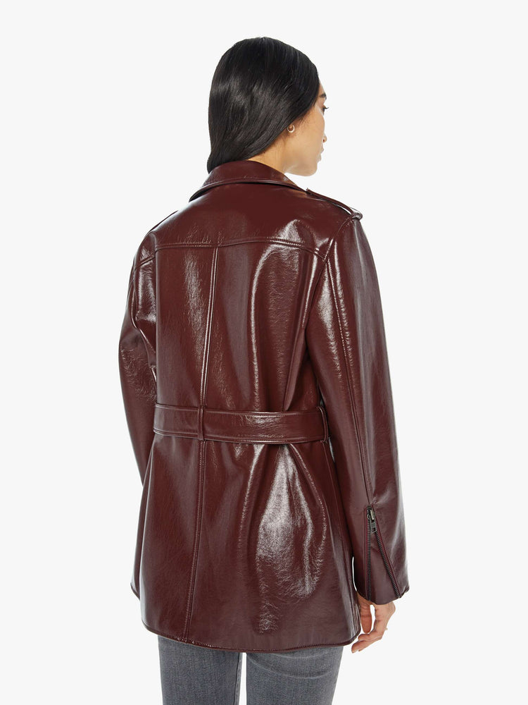 Back view of a woman in a buttery faux leather oversized faux-leather jacket with a notched collar, belted waist, zip pockets and an extra-long hem.