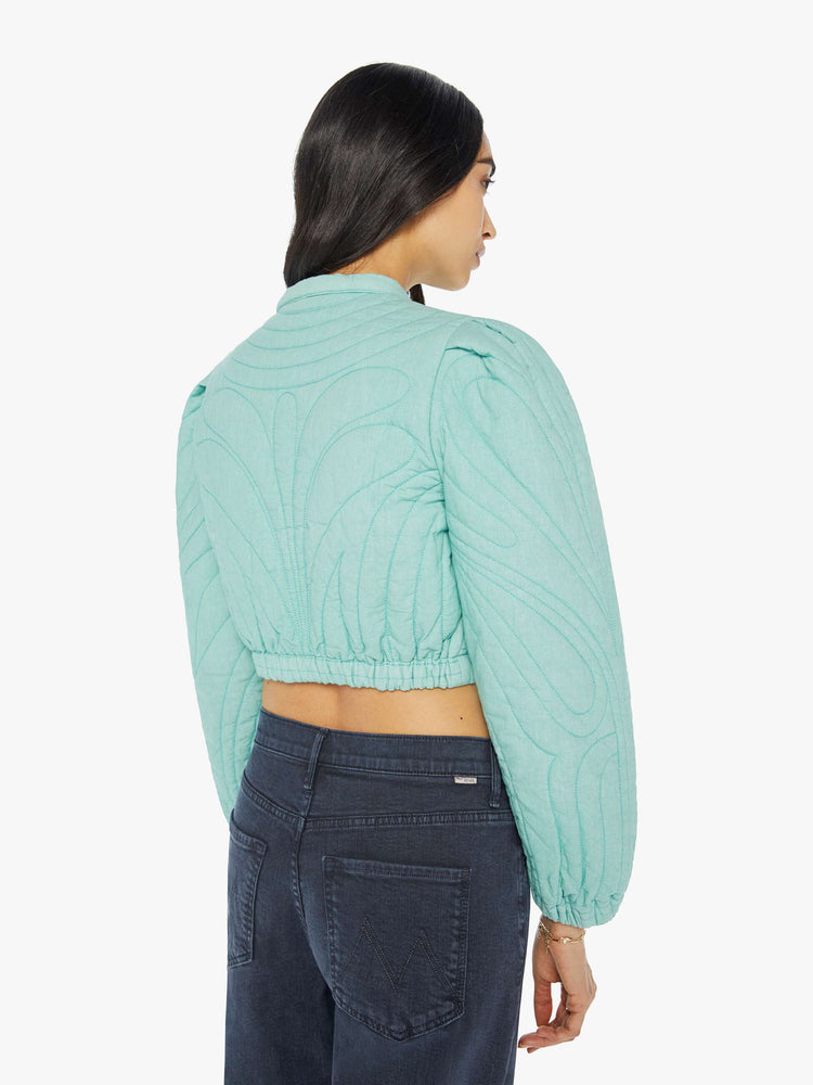 Back view of a woman real cropped crewneck jacket with voluminous balloon sleeves, elastic hems, slit pockets and buttons down the front.