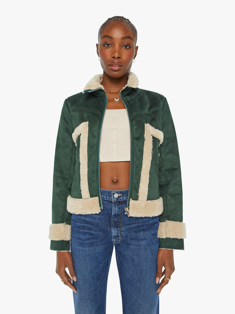 Front view of a woman in a dark green faux suede with cream faux sherpa collared zip-up jacket with a slightly cropped hem and a boxy fit.